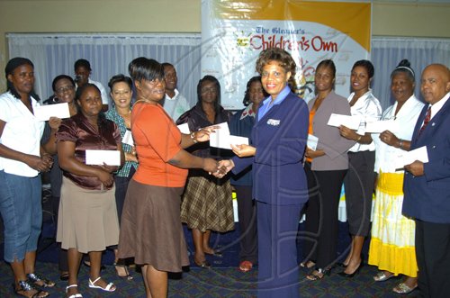Winston Sill/Freelance Photographer
DonnaMarie Brooks-Gordon, Public Relations and Promotion Executive of Courts presents a gift voucher to Marlise Cowie-Adianasing, teacher of the Portland parish champion.