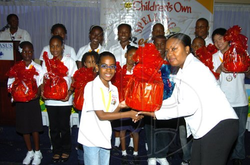Winston Sill/Freelance Photographer
Paula Blake-Asphaal, Sales Manager of Jamaica Flour Mills presents a gift basket to Andriena Cribb, St. James Parish Champion.