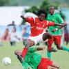 Ricardo Makyn/Staff Photographer.
August Town's Terrence Shaw leaps over a challenge from Humble Lions' Dion Sterling during their National Premier League play-off match at the Mona Bowl yesterday. The match ended 0-0. Sterling's teammate Keveral Stewart looks on.