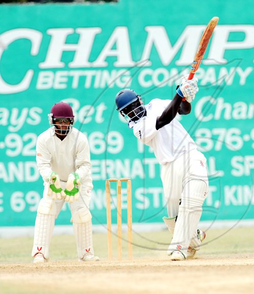 Ricardo Makyn/Staff Photographer.
Melbournes Wicket Keeper Carlton Baugh Junior looks on as  of Kingston's Chadwick Walton hits four on His way to a Century  in thier encounter at Melbourne on Sunday 7.6.2009.