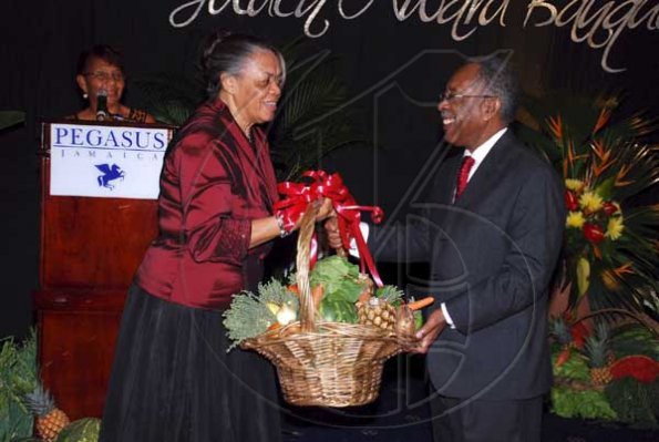 Colin Hamilton/freelance photographer
DCP Jevene bent?presents a basket of St Bess produce to the guest speaker ?Mr Earl Patrick of the TPDCo. during
St. Elizabeth Homecoming Foundation 17th Annual Golden Awards Banquet held at the Pegasus Hotel on Wednesday November 25, 2009.
