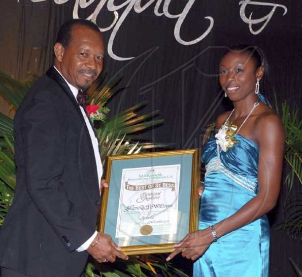 Colin Hamilton/freelance photographer
Olympic Medallist Sherika Williams receives a sports?award from Mr Kenny Jackson (Chairman - Homecoming Week Committee) during St. Elizabeth Homecoming Foundation 17th Annual Golden Awards Banquet held at the Pegasus Hotel on Wednesday November 25, 2009.