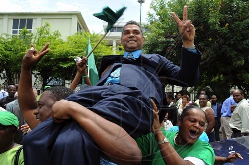 Ian Allen/Staff Photographer
Michael Stern being carried by supporters outside the Supreme Court after the judge ruled that a Bi-election is to be held in the North West Clarendon constituency.