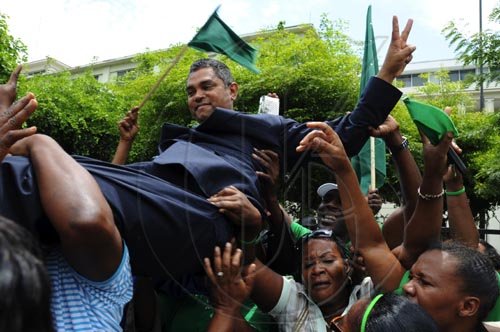 Ian Allen/Staff Photographer
Michael Stern being carried by supporters outside the Supreme Court after the judge ruled that a Bi-election is to be held in the North West Clarendon constituency.