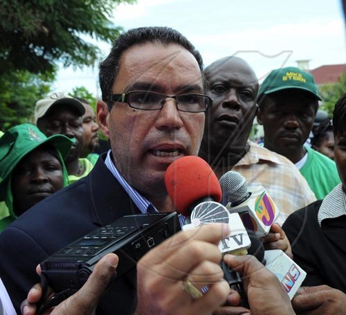 Ian Allen/Staff Photographer
Daryl Vaz talk with members of the media outside the Supreme Court after the judge ruled that a Bi-election is to be held in the North West Clarendon constituency.