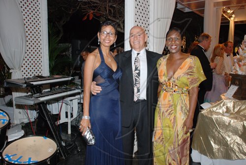 Janet Silvera Photo

Palmyra Resort and Spa's Bob Trotta (centre) is sandwiched by Rose Hall Development's Krystina Stephens and Whitter Village's Angella Whitter at the Hanover Charities annual Sugar Cane Ball at the Round Hill Hotel and Villas last Saturday night.