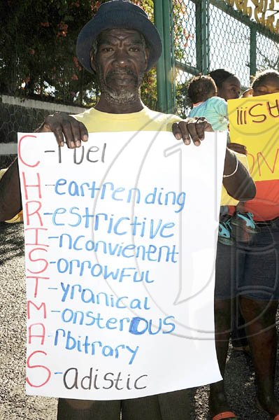 Ian Allen/Photographer
A protestor chastises the previously announced tax by the Government, during the People's National Party planned demonstrations in Highgate, St Mary on Wednesday.