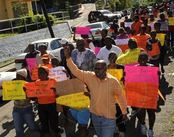 Ian Allen/Photographer

Dr Morais Guy (right), Member of Parliament for Central St Mary and chairman of the People's National Party (PNP) Region Two leads a band of protesters though the streets of Highgate, St. Mary yesterday.