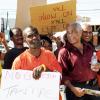 Norman Grindley /Chief Photographer
Opposition spokesman on Finance, Dr Omar Davies, at second from right with water bottling in hand, is fully enjoying the ?shaded? protection of a band of ?no taxMas? protesters gathered at Mandela Highway in Kingston on Wednesday, December 23, 2009, to voice opposition to the new $21.8 billion tax package announced December 17 by the Bruce Golding Administration. The protest was organized by the People?s National Party, who have called the measures ?wicked and unsconsionable? because of its expected impact on lower income groups.