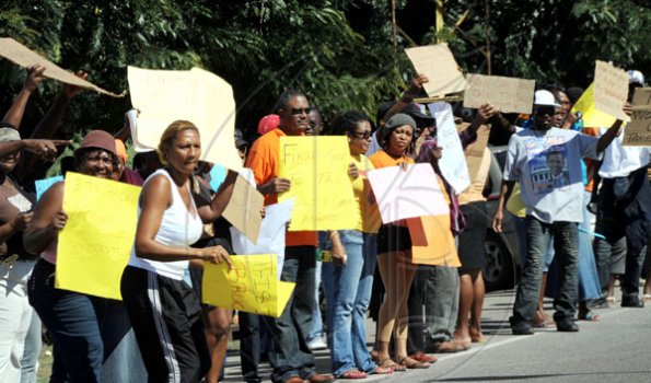 Norman Grindley/Chief Photographer
Former Member of Parliament for Northern Clarendon Horace Dalley (in orange) joins protesters along Mandela Highway yesterday.