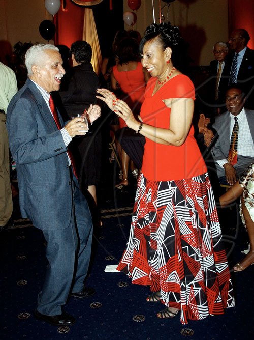 Winston Sill / Freelance Photographer
Col. Trevor MacMillan shakes a leg with Trinidad & Tobago's Ambassador Yvonne Gittens-Joseph. at the 47th Independence Day reception, held at the Jamaica Pegasus hotel, New Kingston on Monday night.

 August 31, 2009.