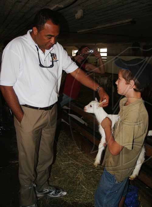 JIS PHOTOS



Minister of Agriculture and Fisheries, Hon. Dr. Christopher Tufton (left), examines a baby goat being held by nine-year-old Luke Oude Egberink, when the Minister and his delegation visited Egberink Goat Farms in Ontario, Canada, recently.