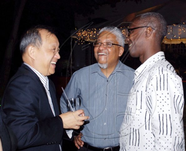 Colin Hamilton/freelance photographer
UWI Vice Chancellor Professor E. Nigel Harris (centre) gets a good laugh with Chinese Ambassador Chen Jinghua (left) and Willie Iton at his reception.

 at #1 Long Mountain Road on Tuesday December 29, 2009.
