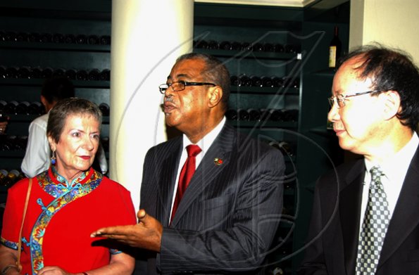 Winston Sill / Freelance Photographer
Tony Pickersgill (centre) makes a point to Irena Cousins and Gregory Hugh-Sam at the Jamaica China Friendship Association (JCFA) banquet to celebrate the 60th Anniversary of the Founding of The Peoples's Republic of China, held at Jade Garden Restaurant, Sovereign Centre on Sunday October 11, 2009.