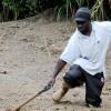 Ian Allen/Photographer
A man tries to free himself from mud that blocked section of the Guava Ridge to Mavis Bank main road in St Andrew after overnight rains caused landslides in the area.
