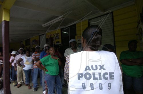 Ricardo Makyn/Staff Photographer
A one day police looking on at the? Mount Pleasant All Age Polling Station.