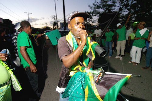 Ricardo Makyn/Staff Photographer
JLP supporters celebrate Daryl Vaz's victory in Buff Bay, Portland, Monday evening.

on Monday 23.3.2009.